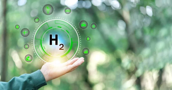 Hand holding clean hydrogen energy world with eco environment icon, Save world, technology sustainable alternative environment concept. Energy of natural gas sustainable and business on green background.