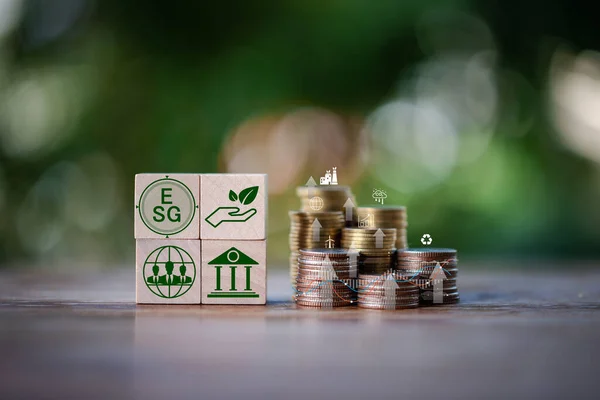 Investing in the environment, society, governance. ESG Investing in the industrial. Green energy invest instead gold coins growing. Concept of Savings in ESG Mutual Funds, Sustainable Business.