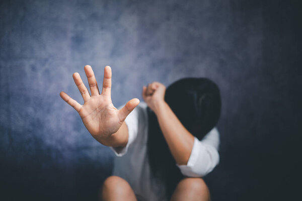 Stop violence against Women, international women's day. Young depressed woman, domestic and rape violence,beaten and raped sitting in the corner.