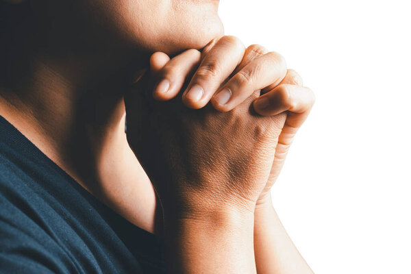 Woman side who believes in god, person hands praying on isolated white background. Asian woman stands in meditative pose, holds hands in praying gesture, has sense of inner peace, Religion concept.