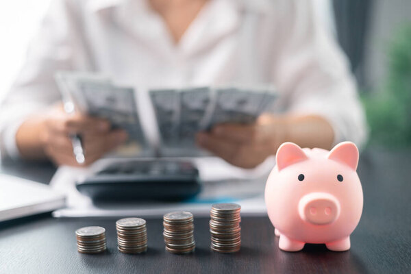 Piggy bank with business stuff, business and finance concept. Business diagram on financial report with coins. Investment results to report to his boss at the meeting.
