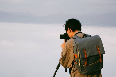Kameralı gezgin, sırt çantalı, doğa yürüyüşü, seyahat yaşam tarzı ve macera konsepti. Yeşil dağ turu, doğanın güzelliği ve turizmin geniş gökyüzü insanları için turistlere katılın.