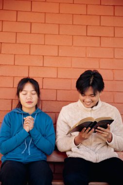 Close up christians hands pray to God with spiritual faith on holy bible in catholic church religion worship prayer ask god bless pray grace jesus believe Christianity religion prayer holy worship. clipart