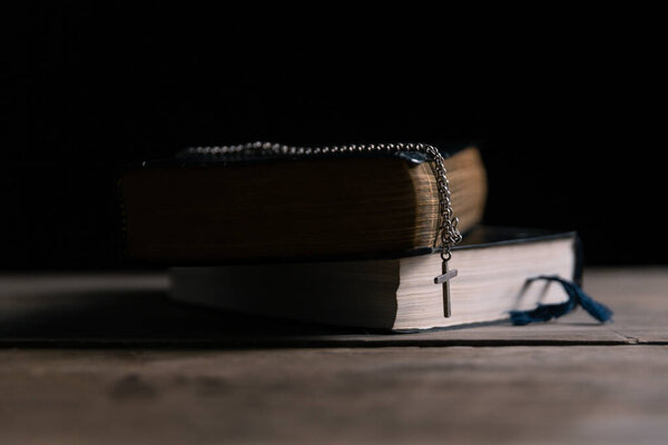 Religious belief concept Close up prayer Christian church service Bible Holy cross Spiritual power Blurred background Desk copy space Heaven God Catholic faith Praise book Jesus worship Gospel symbols