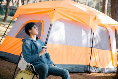 Kafe, kahveyi doğayla uyum içinde yetiştirmeye organik tohum sıcak fincan kafein ve arka plan yeşili açık havaya odaklanıyor. aromatik içecek, bardaktan yükselen zengin aroma.