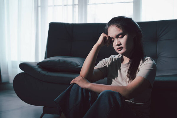 Sorrowful woman sat alone, overwhelmed by emotion, her sad and unhappy expression revealing deep despair, stress and distress left feeling depressed. sorrowful sad, despair alone, depressed stress