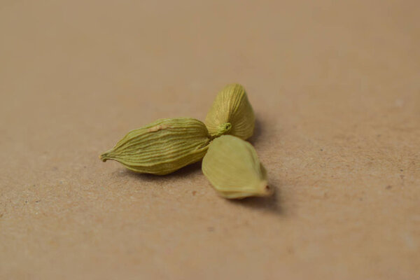 Dried Cardamom Seeds Isolated Background Close-Up View isolated on Yellow Background