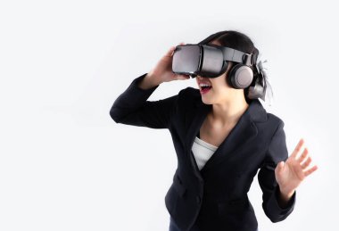 Metaverse concept, young asian businesswoman shot hair style wearing vr goggles headset playing watching and poising on white background.	