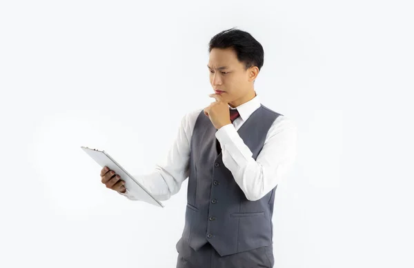 Asian Businessman Grey Suit Holding Tablet Looking Reading White Background — Foto Stock