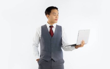 Asian businessman holding and looking at laptop computer white background. Business and technology concept.	