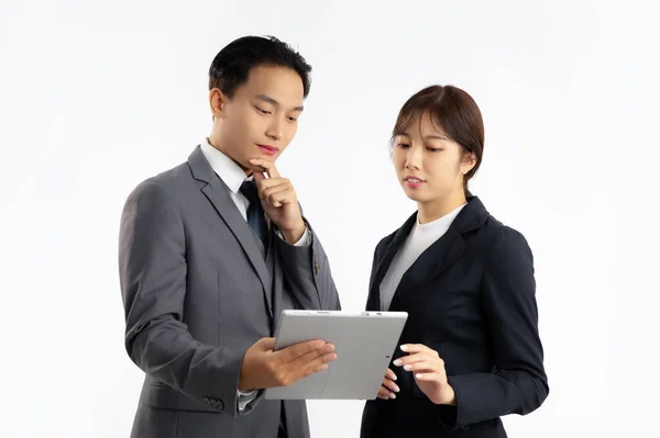 stock image Asian businesspeople man and woman looking at lablet on white background.	