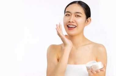 Beauty and spa concept, young asian woman portrait face with healthy skin applying cream on clean face white background.