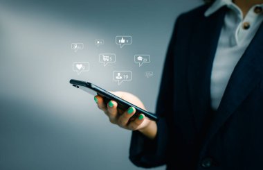 Businesswoman using smartphone in hand with Social media concept.