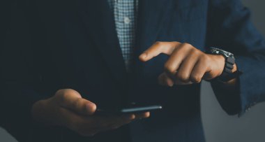 Businessman holding a smartphone. technology IoT, internet of things concept.