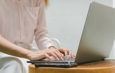 Woman typing on laptop computer. Online internet marketing, freelance, working from home, online education concept.	