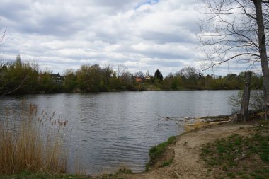 Gorgeous landscape with lake Wuhlesee and its surrounding vegetation in April. Marzahn-Hellersdorf, Berlin, Germany
