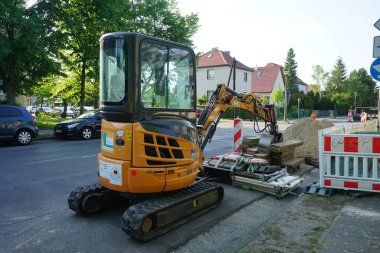 Mini excavator 2,6t Case CX26B at a construction site on the road. Berlin, Germany