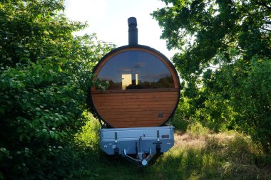 Mobile barrel sauna stands by the lake. Berlin, Germany