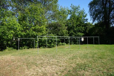 Yıkanmış çarşaf için metal destekleri yazın bir apartmanın avlusuna yerleştirilir. Berlin, Almanya