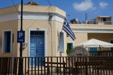 The Greek flag is on a building in Lardos. The national flag of Greece, popularly referred to as the 