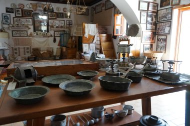 Lardos, Güney Ege bölgesi, Yunanistan - 29 Ağustos 2022: Rodos adasındaki Folklor Müzesi 'nde antik metal kaplar ve primus sobaları masada duruyor. 