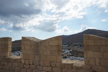 Ağustosta antik Lindos Akropolü 'ndeki kale duvarının manzarası. Bir akropolis, antik bir Yunan şehrinin üst kesimlerinin yerleşim yeriydi. Lindos, Rodos Adası, Dodecanese, Yunanistan  