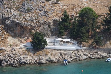 Lindos 'taki St. Paul Körfezi manzarası. Lindos, bir arkeolojik alan, bir balıkçı köyü ve Dodecanese 'de Rodos adasının eski bir belediyesi. 