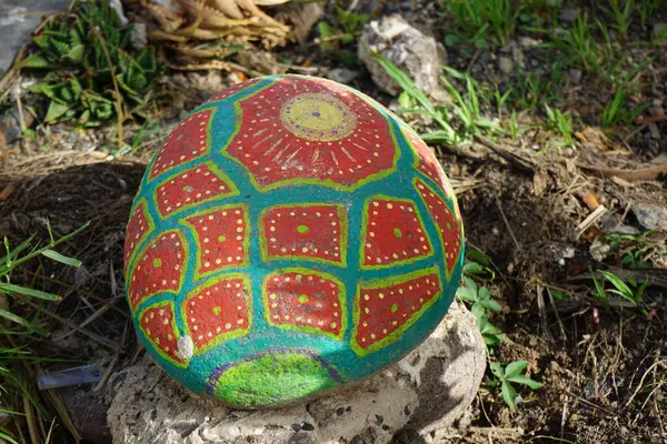 stock image Costa Calma, Fuerteventura, Spain - October 24, 2022: A painted stone decorates a flowerbed near the Avenida Happag Lloyd road in Costa Calma.