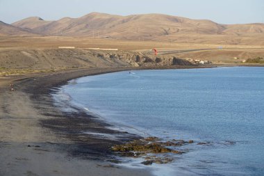Bir uçurtma sörfçüsü, Matas Bay 'de, Matas de Blancas plajı boyunca sonbaharda Atlantik Okyanusu' nun dalgaları üzerinde sörf tahtasına biner. Uçurtma sörfü ya da uçurtma uçurmak rüzgar enerjisi gerektiren bir spordur. Costa Calma, Fuerteventura, Kanarya Adaları.