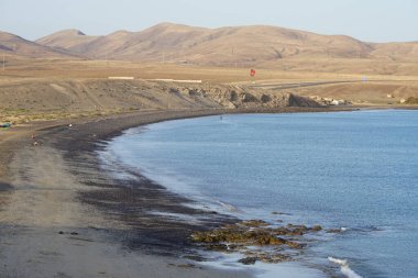 Bir uçurtma sörfçüsü, Matas Bay 'de, Matas de Blancas plajı boyunca sonbaharda Atlantik Okyanusu' nun dalgaları üzerinde sörf tahtasına biner. Uçurtma sörfü ya da uçurtma uçurmak rüzgar enerjisi gerektiren bir spordur. Costa Calma, Fuerteventura, Kanarya Adaları.
