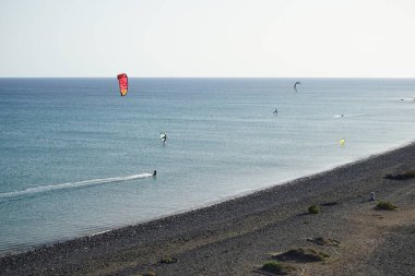 Kiteboarders and wingfoilers are extreme water sports on the Atlantic Ocean in Matas Bay. Kiteboarding or kitesurfing is a sport that involves using wind power. Costa Calma, Fuerteventura, Las Palmas, Canary Islands, Spain. 