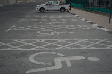 Disabled parking spaces are available at Khor Fakkan. Khor Fakkan is a city and an exclave of the Emirate of Sharjah, located on the east coast of the United Arab Emirates, UAE.  clipart