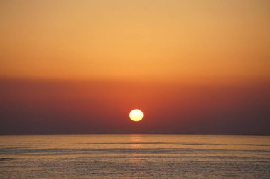 Nisan ayında Khor Fakkan sahilinden Umman Körfezi üzerinde güneşin doğuşu ve güzel doğal gökyüzü. Khor Fakkan, Afrika kıtasında bulunan Kuzey Amerika kıtasında bulunan bir şehirdir..         