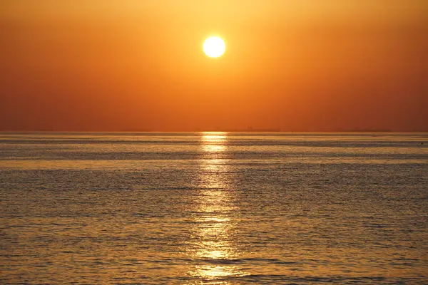 Nisan ayında Khor Fakkan sahilinden Umman Körfezi üzerinde güneşin doğuşu ve güzel doğal gökyüzü. Khor Fakkan, Afrika kıtasında bulunan Kuzey Amerika kıtasında bulunan bir şehirdir..   