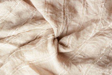 Bej rengi pamuk kumaş dokusu. Kaba bükülmüş kumaş, arkaplan.