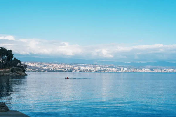 stock image Beautiful blue sea with fishing boat. View of Rijeka city, Croatia.