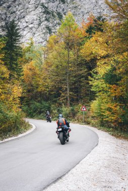 Motosikletliler dağlardaki sonbahar ormanlarında yollara düşerler..