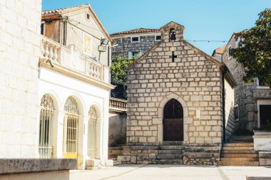 Church and main square of town of Omisalj, Krk island in Croatia. clipart