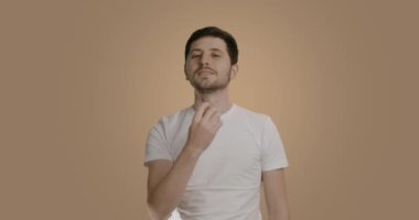 Güzel taranmış sakalını siyah plastik bir tarakla tarayan 30 'lu yaşlardaki genç sakallı bir adamın portresi. Günlük sakal bakımı, sağlıklı yaşam tarzı.
