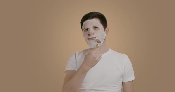 Portret Mężczyzny Robiącego Masaż Jadeitowy Twarzy Kosmetycznej Masce Młody Mężczyzna — Wideo stockowe