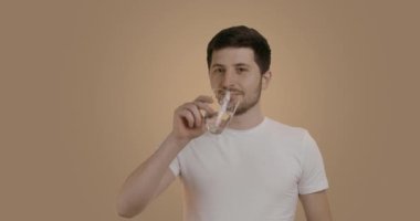 Sabah yapılan tüm hijyen işlemlerinden sonra boş mideyle bir bardak su içen bir adamın portresi. Başarılı bir adamın günlük rutini ve doğruluğu. Sağlıklı yaşam tarzı kavramı