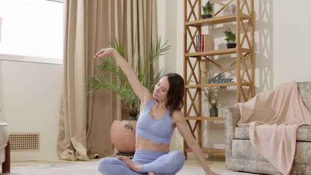 Woman Sitting Carpet Lotus Position Relaxes Meditates Doing Yoga Beautiful — Stockvideo