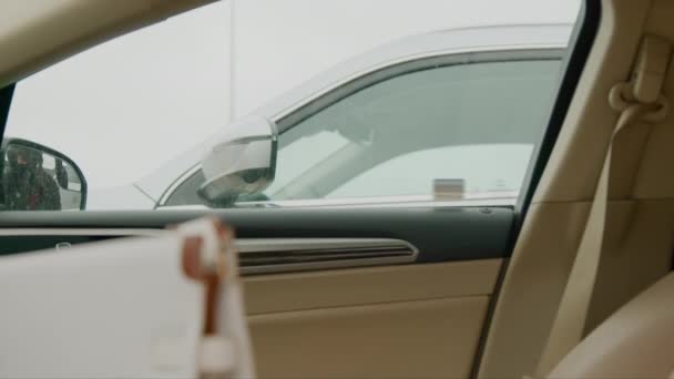 一个身穿黑色帽衫 头戴黑色礼帽的小偷在一个女人的催促下从车窗往外看 车里一阵紧张和期待 — 图库视频影像