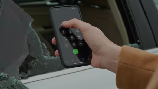 Чоловік Тримає Мобільний Телефон Перед Розбитим Вікном Автомобіля Набирає Аварійний — стокове відео