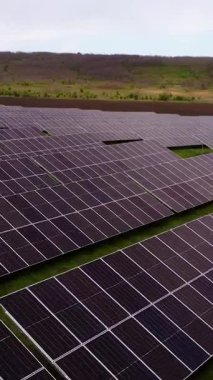 Güneş panelleri gün batımında geniş alanda temiz enerji üreten güneş ışığını emer. Yaz kırsalında sürdürülebilir tarım ürünleri
