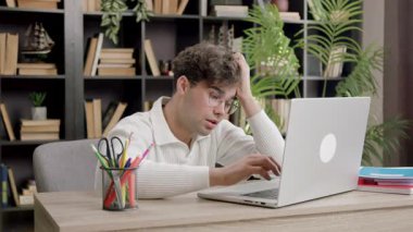 Bilgisayarda çalışan genç bir çocuk bir projede başarılı olamadığı için hayal kırıklığına uğruyor ve yıkılmış durumda. Öğrenci iç geçiriyor ve üniversiteyi motive etmeden çalıştığı için üzgün.