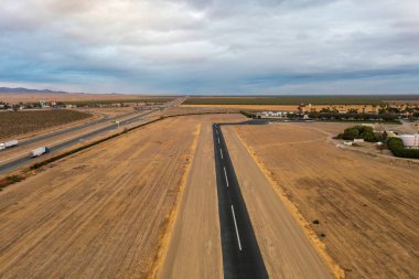 November 5, 2022, Coalinga, California. Landing strip next to Highway 5, Harris Ranch in distance.  clipart
