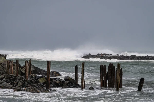 Storm Surge Creates High Waves Crashing Jetty — Photo