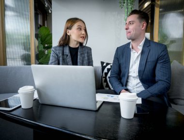 Startup business partners are checking schedules to plan their product launches on time.