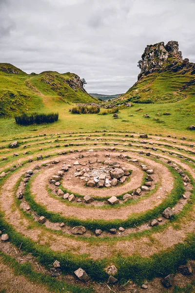 In the enchanting Fairy Glen of Uig, a symmetrical composition unfolds with stone circles as its centerpiece. Mysterious and ancient, the circles are meticulously arranged, creating a sense of balance and harmony in this mystical landscape. It\'s a si